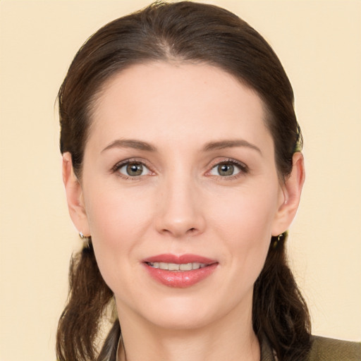 Joyful white young-adult female with long  brown hair and brown eyes