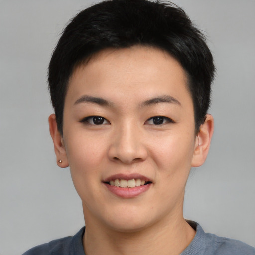Joyful asian young-adult female with short  black hair and brown eyes