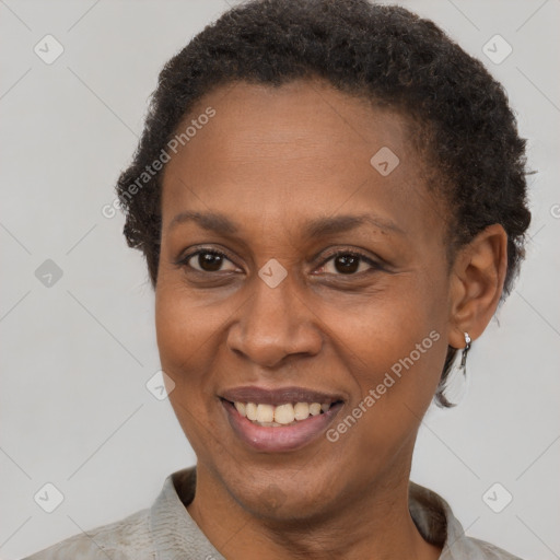 Joyful black adult female with short  brown hair and brown eyes