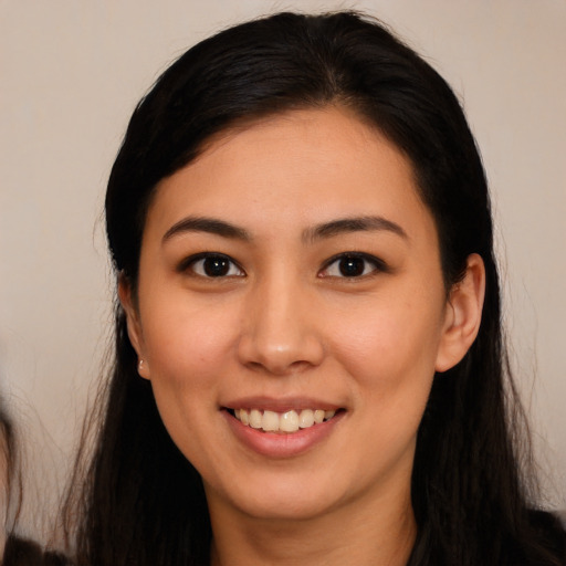 Joyful white young-adult female with long  black hair and brown eyes