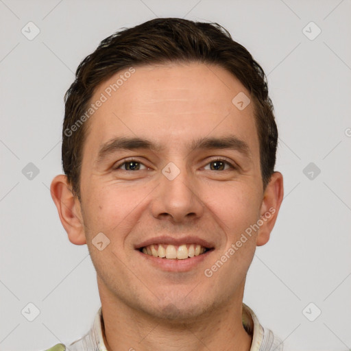 Joyful white young-adult male with short  brown hair and grey eyes