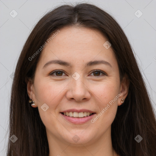 Joyful white adult female with long  brown hair and brown eyes