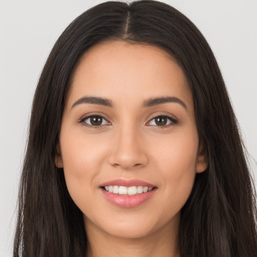 Joyful latino young-adult female with long  brown hair and brown eyes