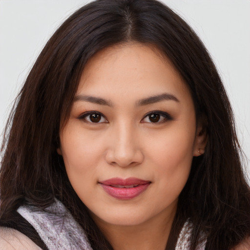 Joyful asian young-adult female with long  brown hair and brown eyes