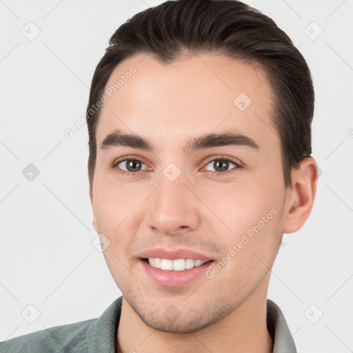 Joyful white young-adult male with short  brown hair and brown eyes