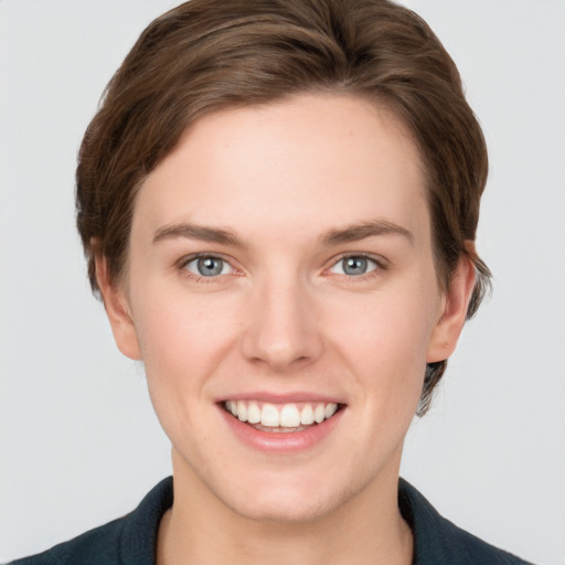 Joyful white young-adult female with short  brown hair and grey eyes