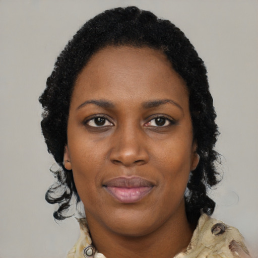 Joyful black young-adult female with medium  black hair and brown eyes