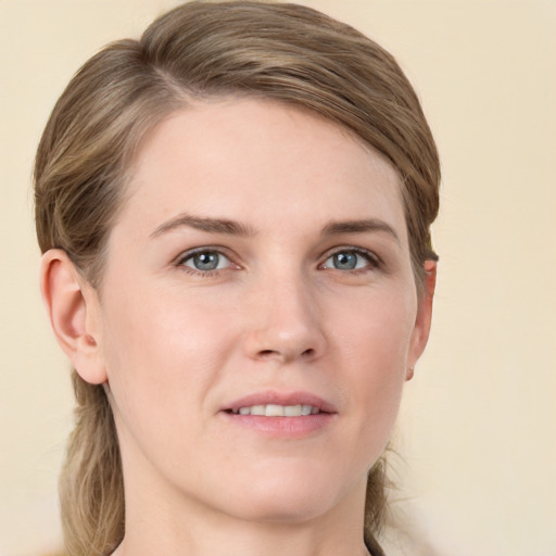 Joyful white young-adult female with medium  brown hair and grey eyes