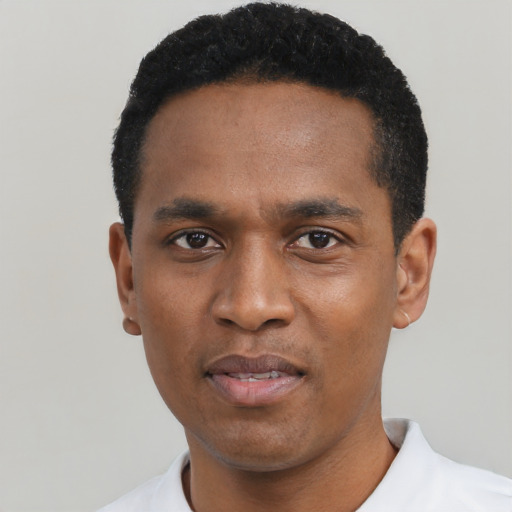 Joyful black young-adult male with short  black hair and brown eyes