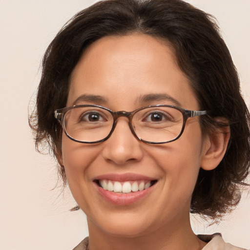 Joyful white adult female with medium  brown hair and brown eyes