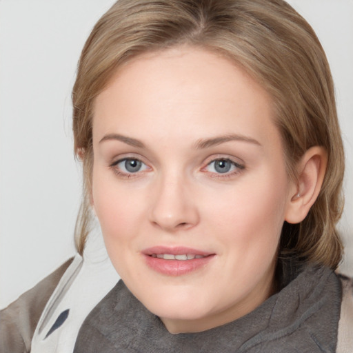 Joyful white young-adult female with medium  brown hair and blue eyes