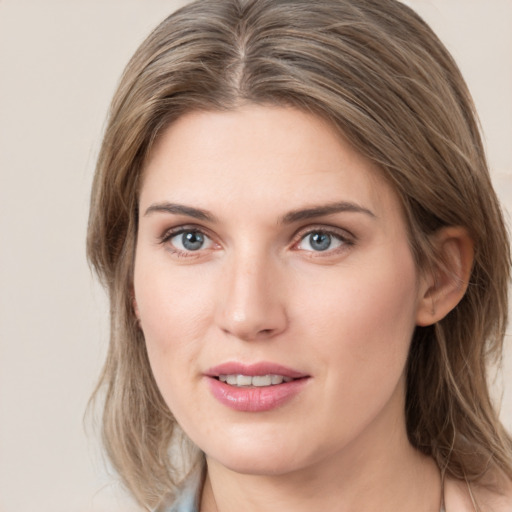 Joyful white young-adult female with medium  brown hair and green eyes