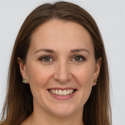 Joyful white young-adult female with long  brown hair and grey eyes