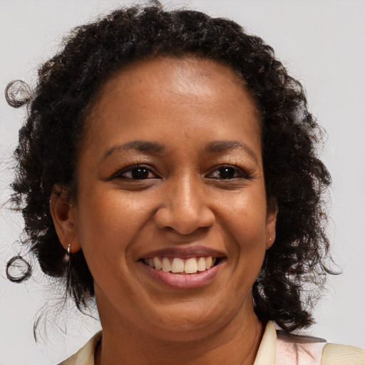 Joyful black adult female with medium  brown hair and brown eyes
