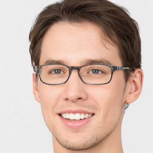 Joyful white young-adult male with short  brown hair and green eyes