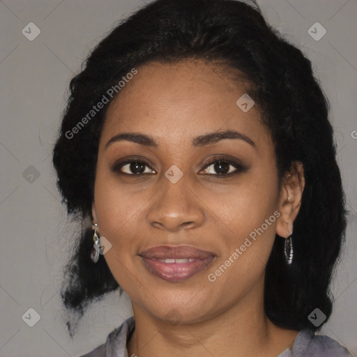 Joyful black young-adult female with long  black hair and brown eyes