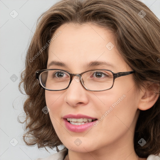 Joyful white young-adult female with medium  brown hair and blue eyes