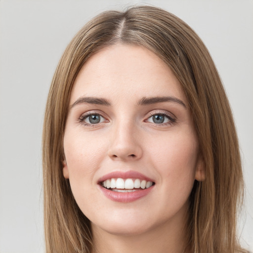 Joyful white young-adult female with long  brown hair and green eyes