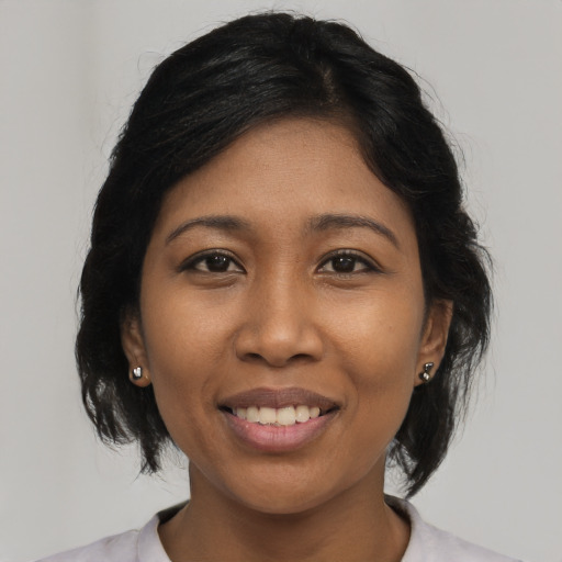 Joyful latino young-adult female with medium  black hair and brown eyes