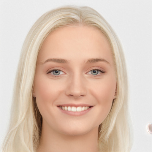 Joyful white young-adult female with long  blond hair and blue eyes