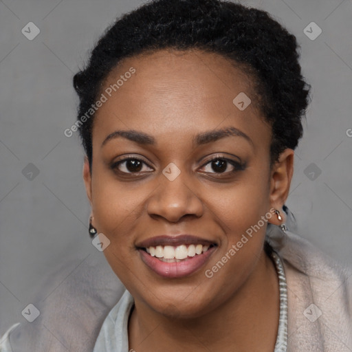 Joyful black young-adult female with short  black hair and brown eyes