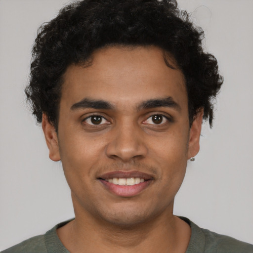 Joyful latino young-adult male with short  brown hair and brown eyes