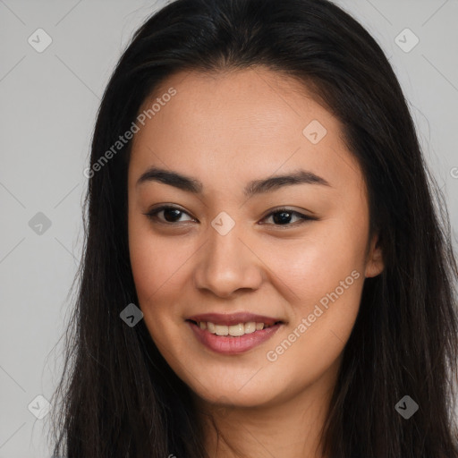 Joyful asian young-adult female with long  brown hair and brown eyes