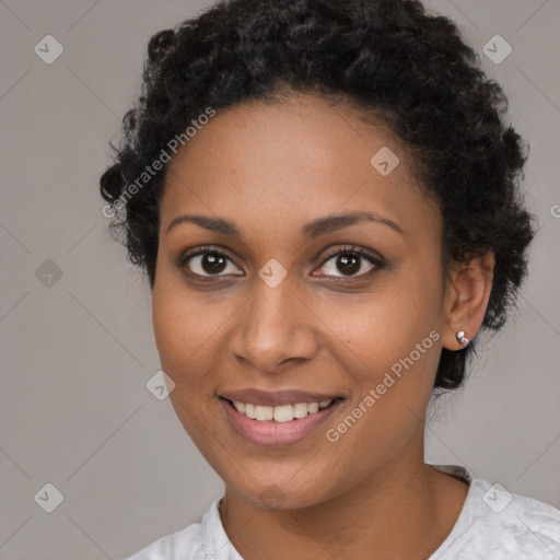 Joyful black young-adult female with short  brown hair and brown eyes