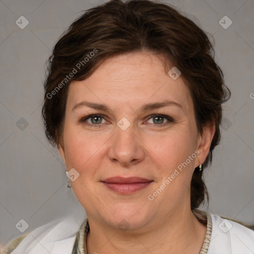 Joyful white adult female with medium  brown hair and blue eyes