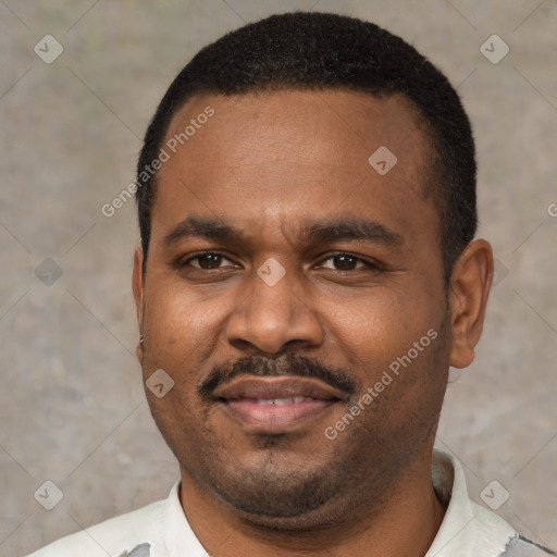 Joyful black young-adult male with short  black hair and brown eyes