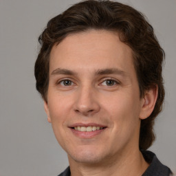 Joyful white young-adult male with medium  brown hair and brown eyes