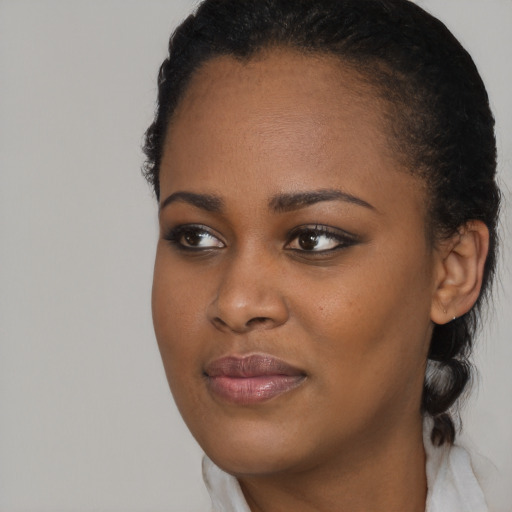 Joyful black young-adult female with medium  brown hair and brown eyes