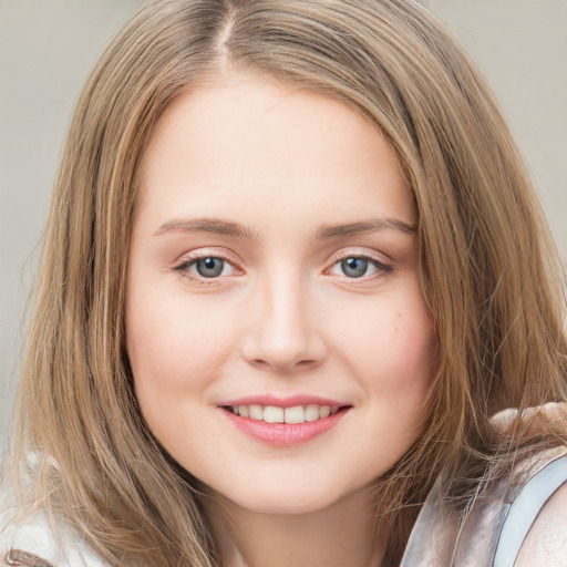 Joyful white young-adult female with long  brown hair and blue eyes