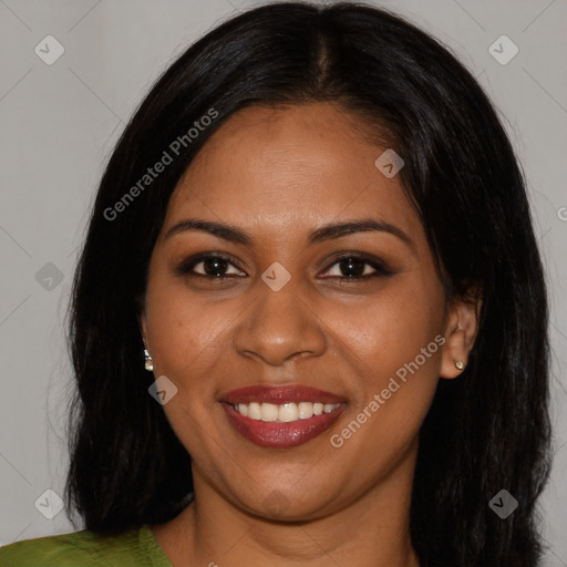 Joyful black young-adult female with long  brown hair and brown eyes