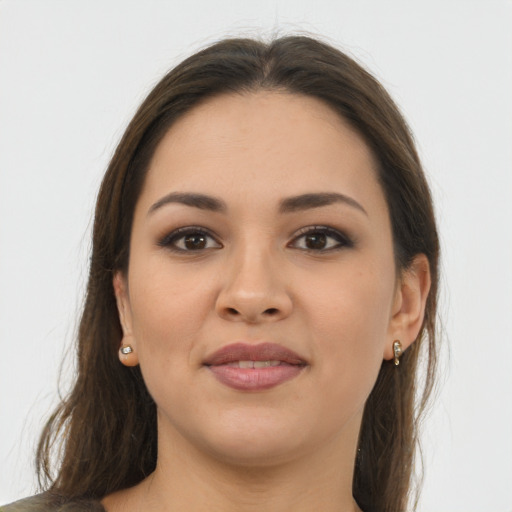 Joyful latino young-adult female with long  brown hair and brown eyes