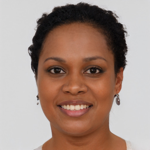 Joyful black young-adult female with short  brown hair and brown eyes