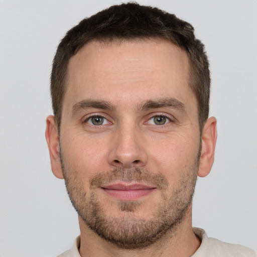 Joyful white young-adult male with short  brown hair and brown eyes