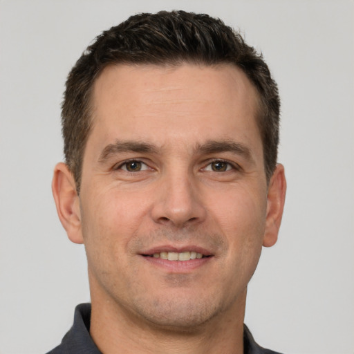 Joyful white young-adult male with short  brown hair and brown eyes