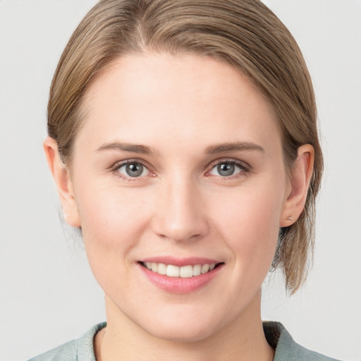 Joyful white young-adult female with medium  brown hair and blue eyes