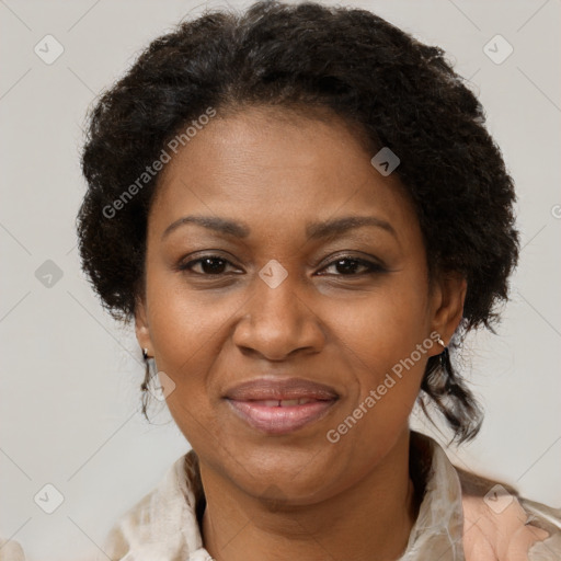 Joyful black adult female with medium  brown hair and brown eyes