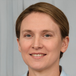 Joyful white adult female with short  brown hair and grey eyes