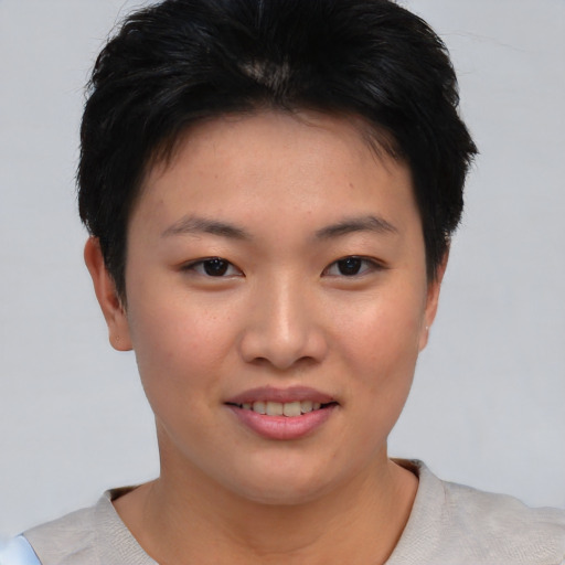 Joyful asian young-adult female with short  brown hair and brown eyes