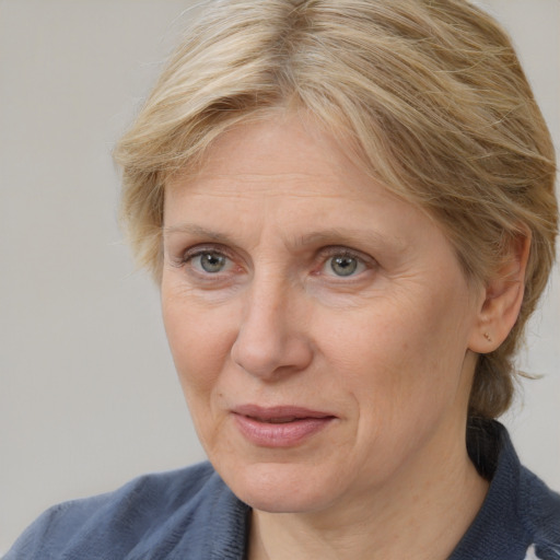 Joyful white adult female with medium  brown hair and blue eyes