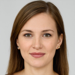 Joyful white young-adult female with long  brown hair and green eyes