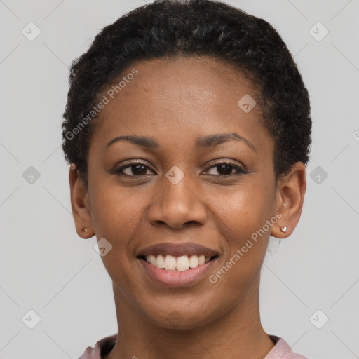 Joyful black young-adult female with short  black hair and brown eyes