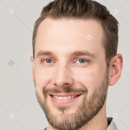 Joyful white adult male with short  brown hair and brown eyes