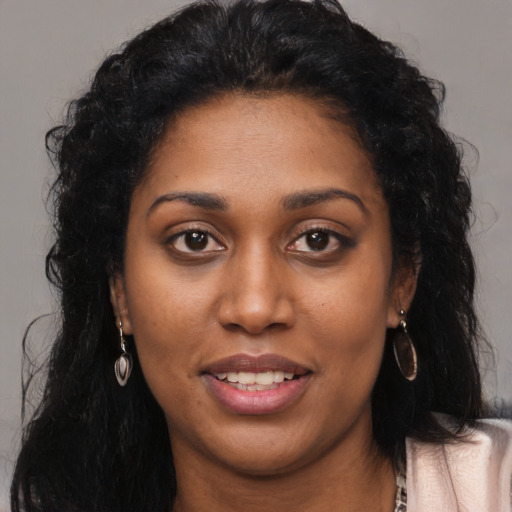 Joyful latino young-adult female with long  black hair and brown eyes