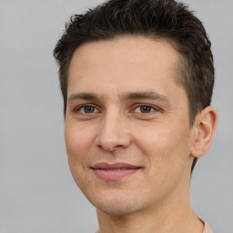 Joyful white adult male with short  brown hair and brown eyes