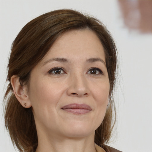 Joyful white adult female with medium  brown hair and brown eyes