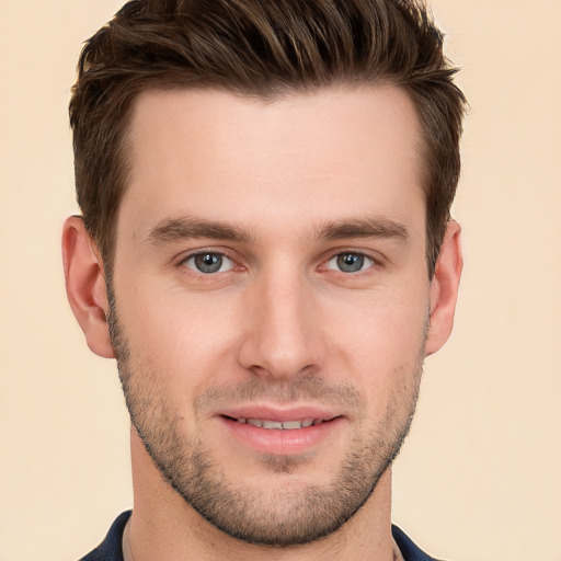 Joyful white young-adult male with short  brown hair and grey eyes